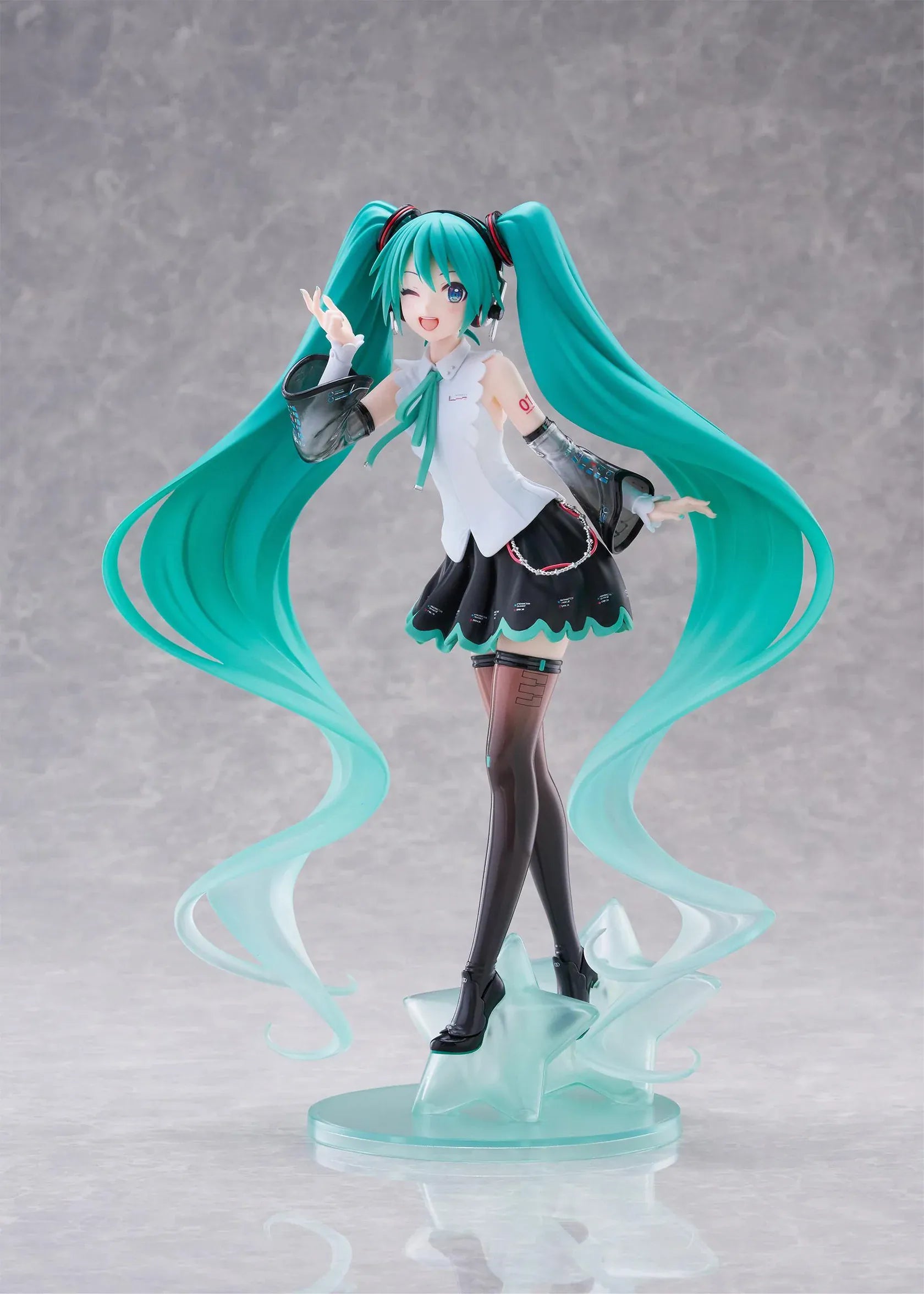 Vocaloid T-Most Hatsune Miku NT Ver. Figure featuring Miku with long teal twin tails, headphones, black-and-white outfit, wink expression, peace-sign pose, and star-themed base.