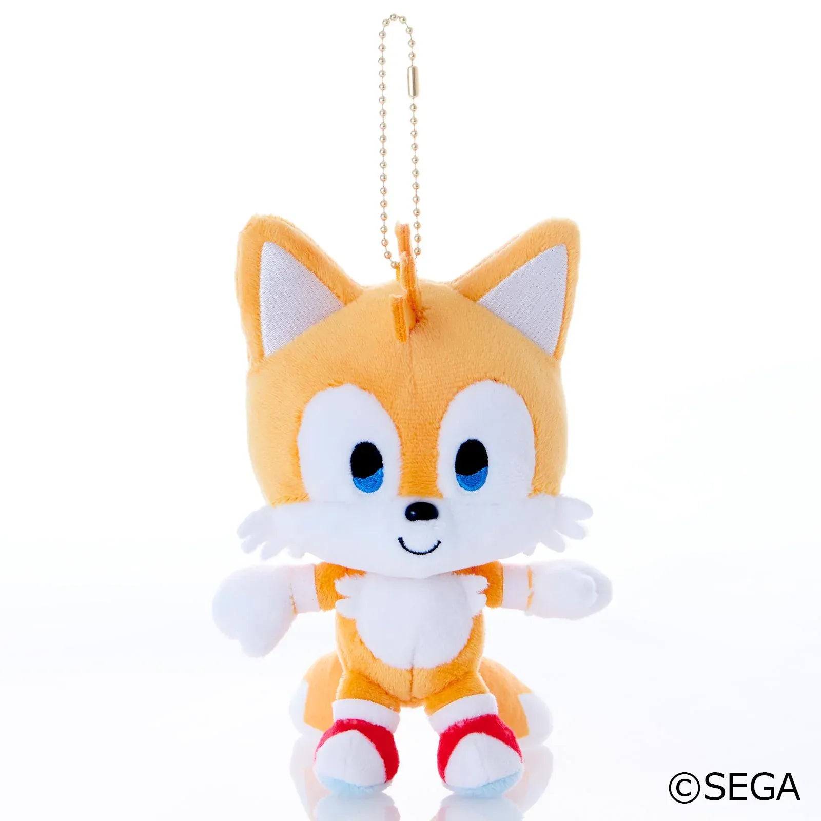 Sonic & Friends Tails mascot plush with blue eyes, red shoes, twin tails, and an attached ball chain.