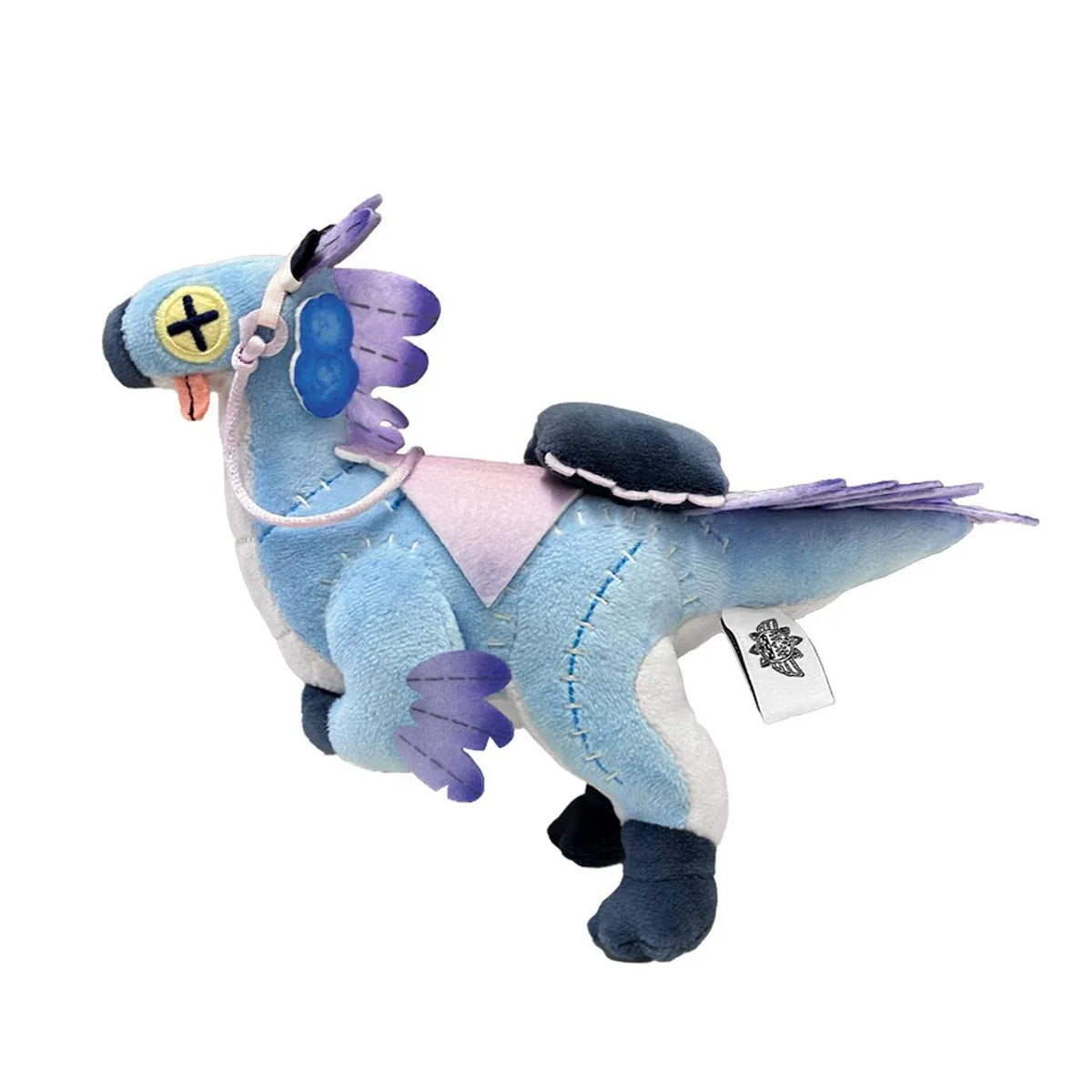 Monster Hunter Wilds Seikret Living Doll Caparison Plushie featuring a blue bird-like companion with purple feathers, button-style eyes, patchwork stitching, a decorative saddle, and dark blue feet.