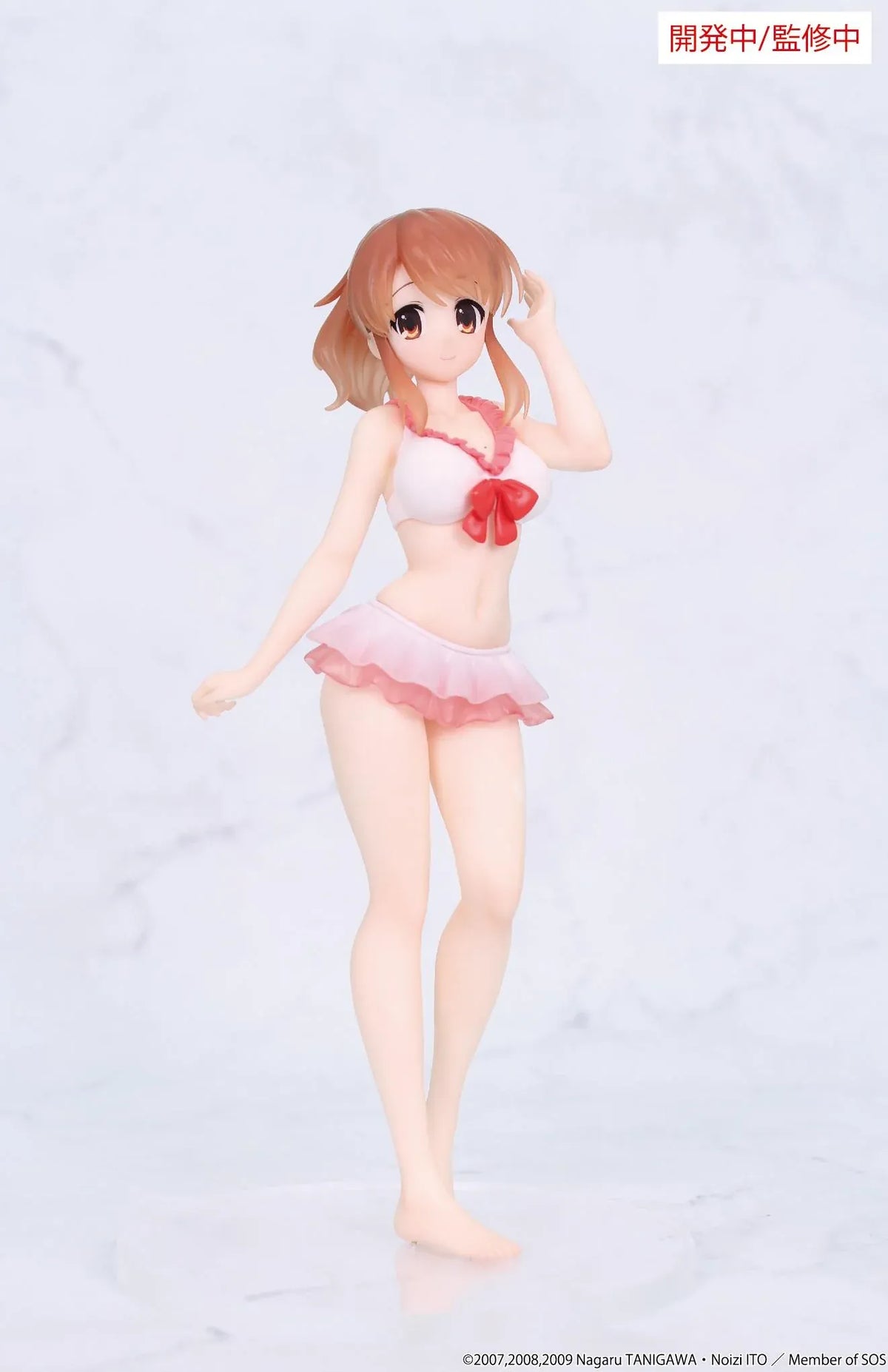 Vivit Mikuru Asahina figure with orange-brown hair, wearing a pink ruffled swimsuit with a red bow, smiling with one hand raised near her bangs.