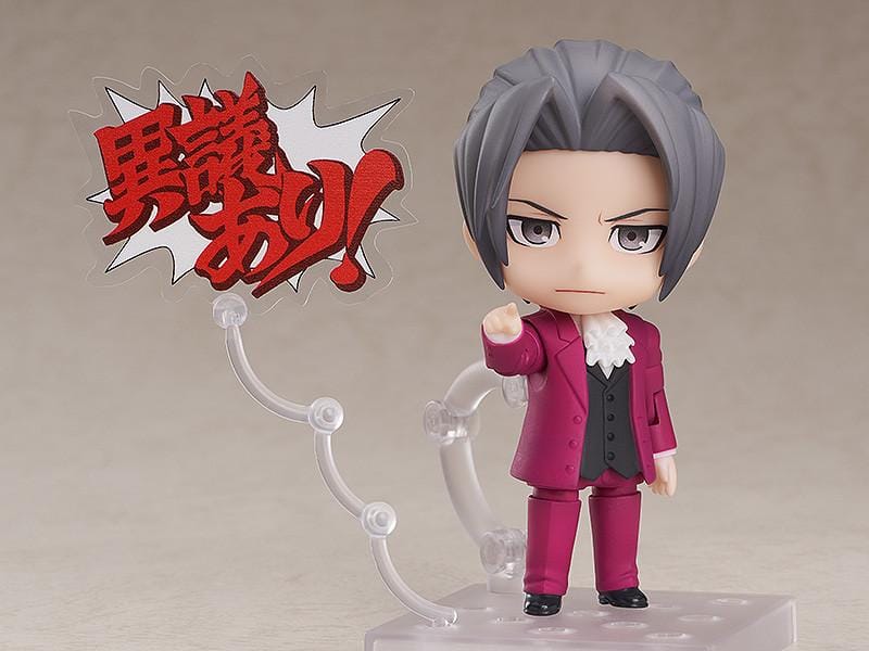 Ace Attorney Miles Edgeworth Nendoroid rerelease figure wearing a burgundy suit and pointing beside a Japanese Objection effect part.