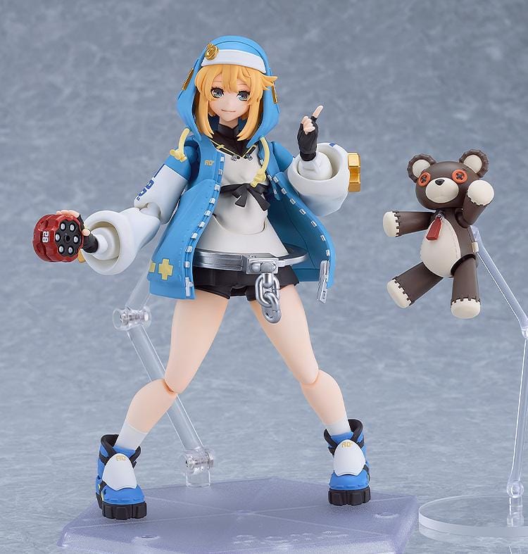 GUILTY GEAR STRIVE figma Bridget Figure featuring Bridget in a blue hoodie outfit with yo-yo accessory, oversized handcuff detail, and teddy bear companion.