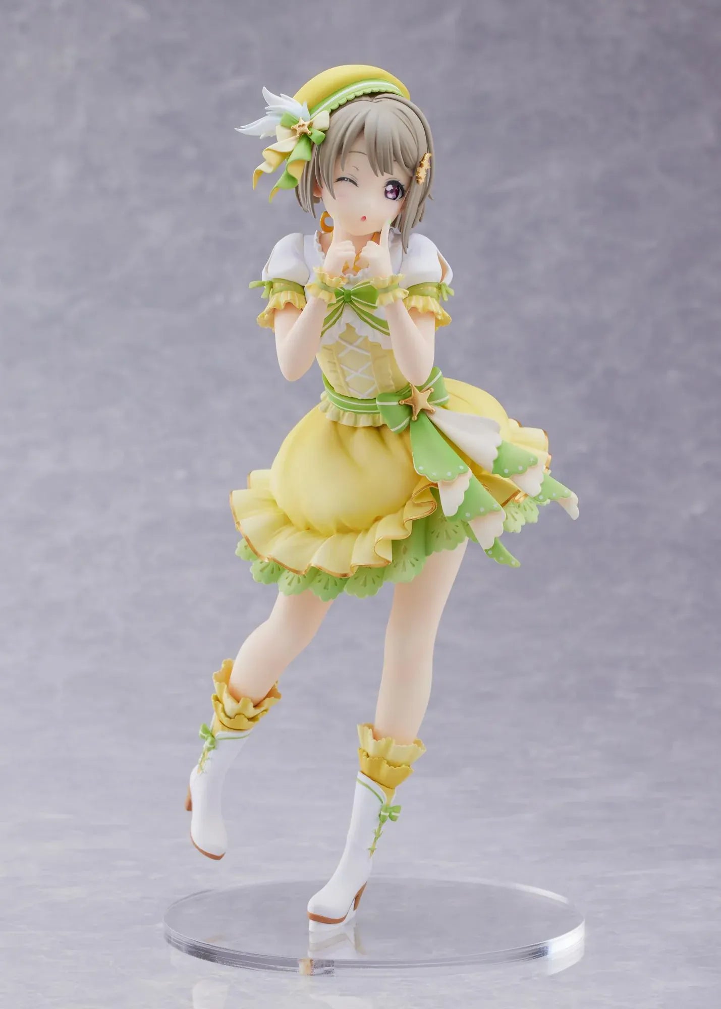 Love Live Nijigasaki High School Idol Club Kasumi Nakasu 1/7 Scale Figure featuring Kasumi in a yellow and green idol outfit with a winking expression, ribbon accents, and matching boots.