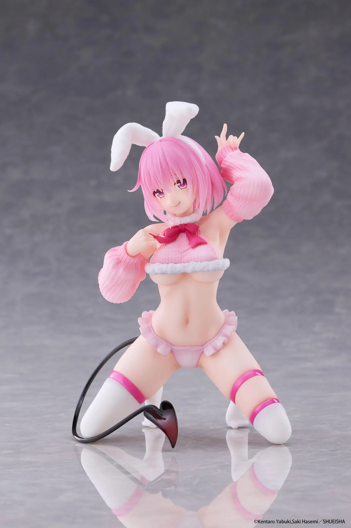 To Love-Ru Darkness MOFLOCK Momo Fluffy Bunny Ver. Figure featuring a pink-haired anime girl with pink eyes, white bunny ears, a pink fluffy bunny outfit, matching sleeves, white thigh-high stockings, and a black devil tail in a playful kneeling pose.