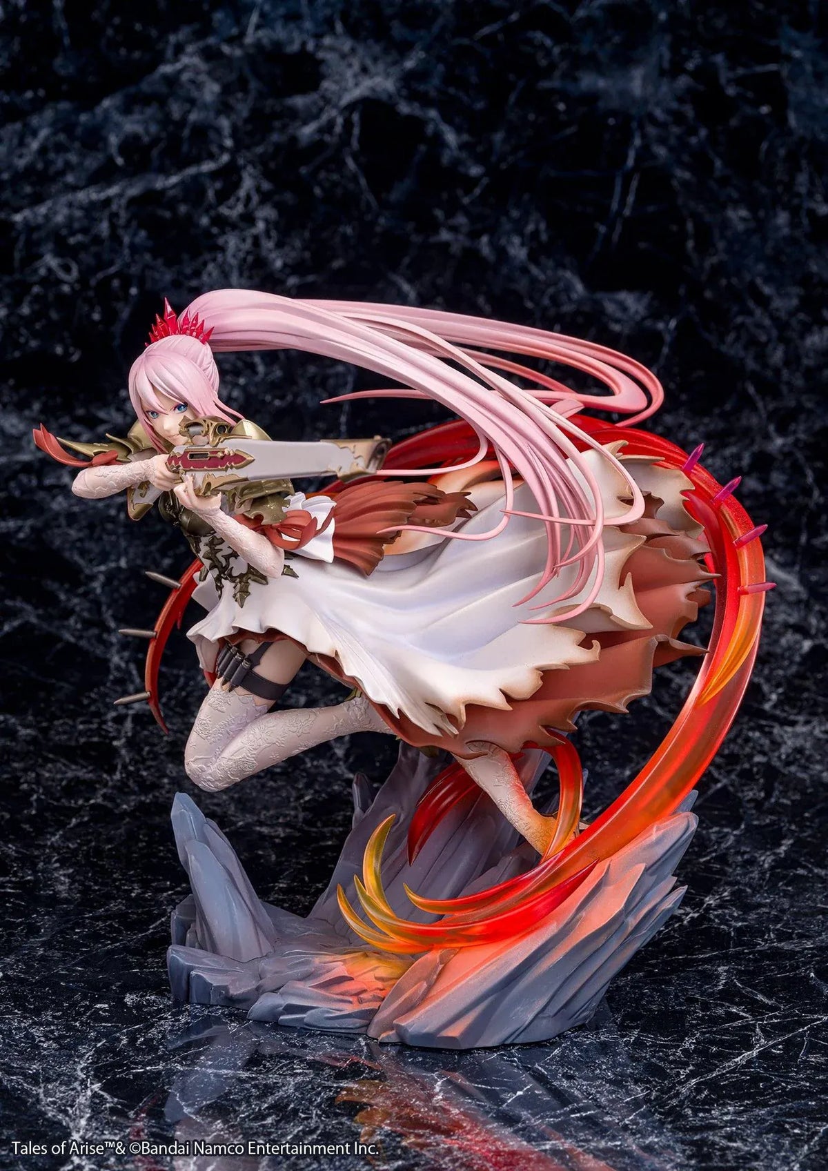 Tales of Arise Shionne 1/7 Scale Figure featuring a pink-haired anime character with blue eyes, an ornate white battle dress, gold armor, and lace stockings, aiming a detailed rifle while suspended in a dynamic pose surrounded by translucent red and orange effects on a rocky display base.