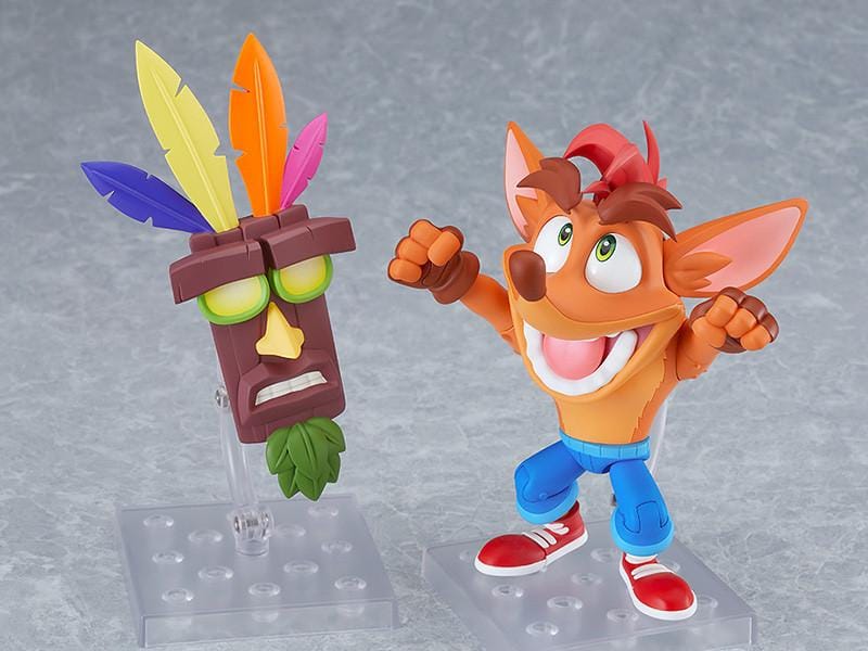 Crash Bandicoot Nendoroid rerelease figure with orange fur, a large grin, blue shorts, and red sneakers in an energetic pose.