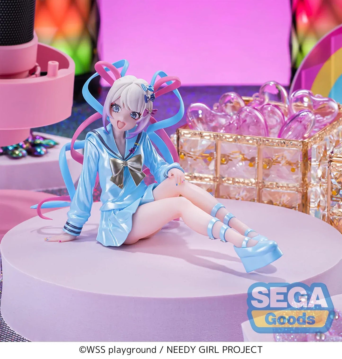 Figure of OMGKawaiiAngel sitting in a perching pose with pastel ribbons, glossy outfit, and energetic expression.