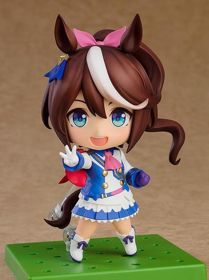 Umamusume Pretty Derby Nendoroid Tokai Teio rerelease figure with brown hair, a white forelock, pink bow, and blue-and-white racing uniform.