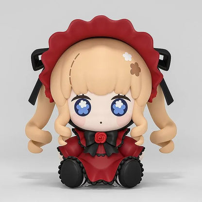 Rozen Maiden Huggy Good Smile Shinku Figure featuring a blonde-haired anime doll with blue eyes, long twin drill curls, a deep red gothic dress, black ribbons, rose decorations, and a matching red bonnet in a cute seated chibi design.