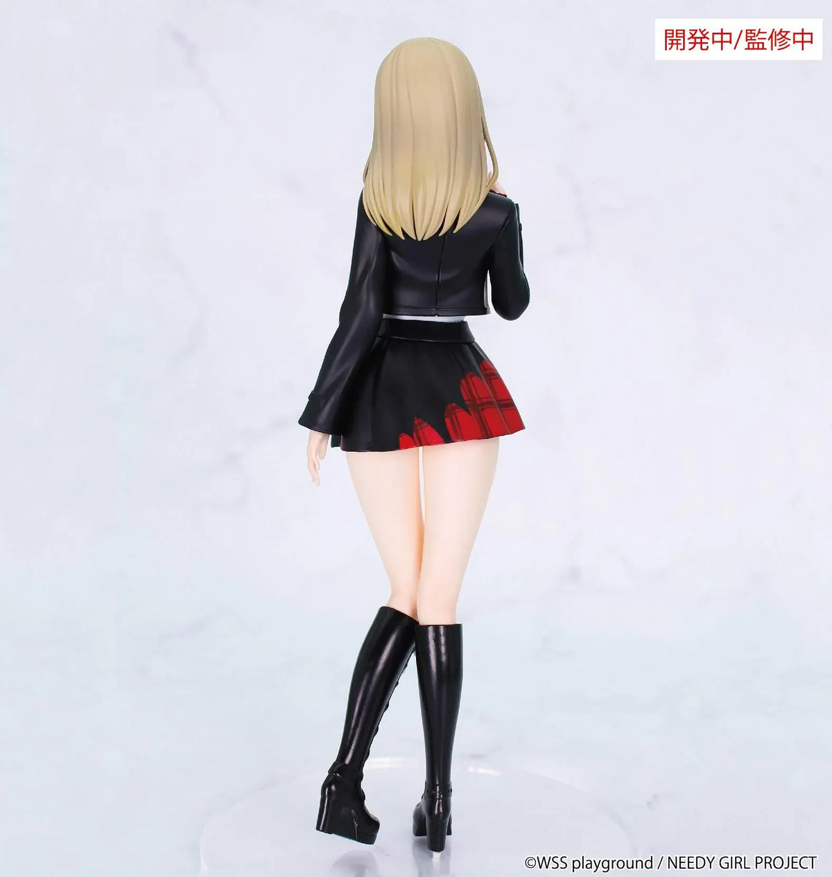 Prototype NEEDY GIRL OVERDOSE Vivit KACHE figure with blond hair, a black jacket, white top, red plaid skirt, and tall black boots with white laces.