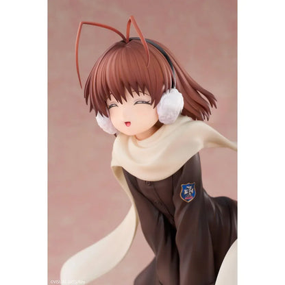 CLANNAD Nagisa Furukawa 1/6 Scale Figure featuring a smiling brown-haired anime girl wearing a dark school uniform, cream-colored scarf, white earmuffs, and black knee-high socks, surrounded by colorful Dango Daikazoku characters.