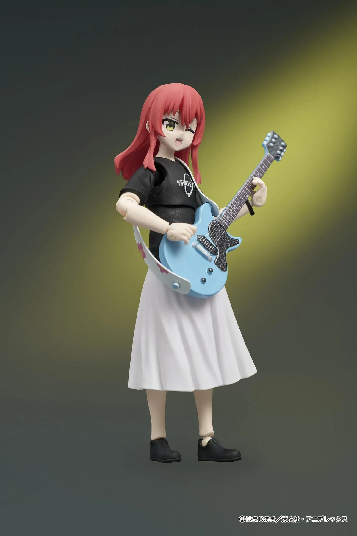 Bocchi the Rock! DIGACTION Ikuyo Kita figure winking while holding a light blue guitar, wearing a black band T-shirt and white pleated skirt.