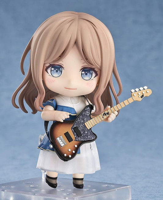 Nendoroid figure of Soyo Nagasaki from BanG Dream! holding a sunburst bass guitar, wearing a blue dress with a white skirt and black shoes.