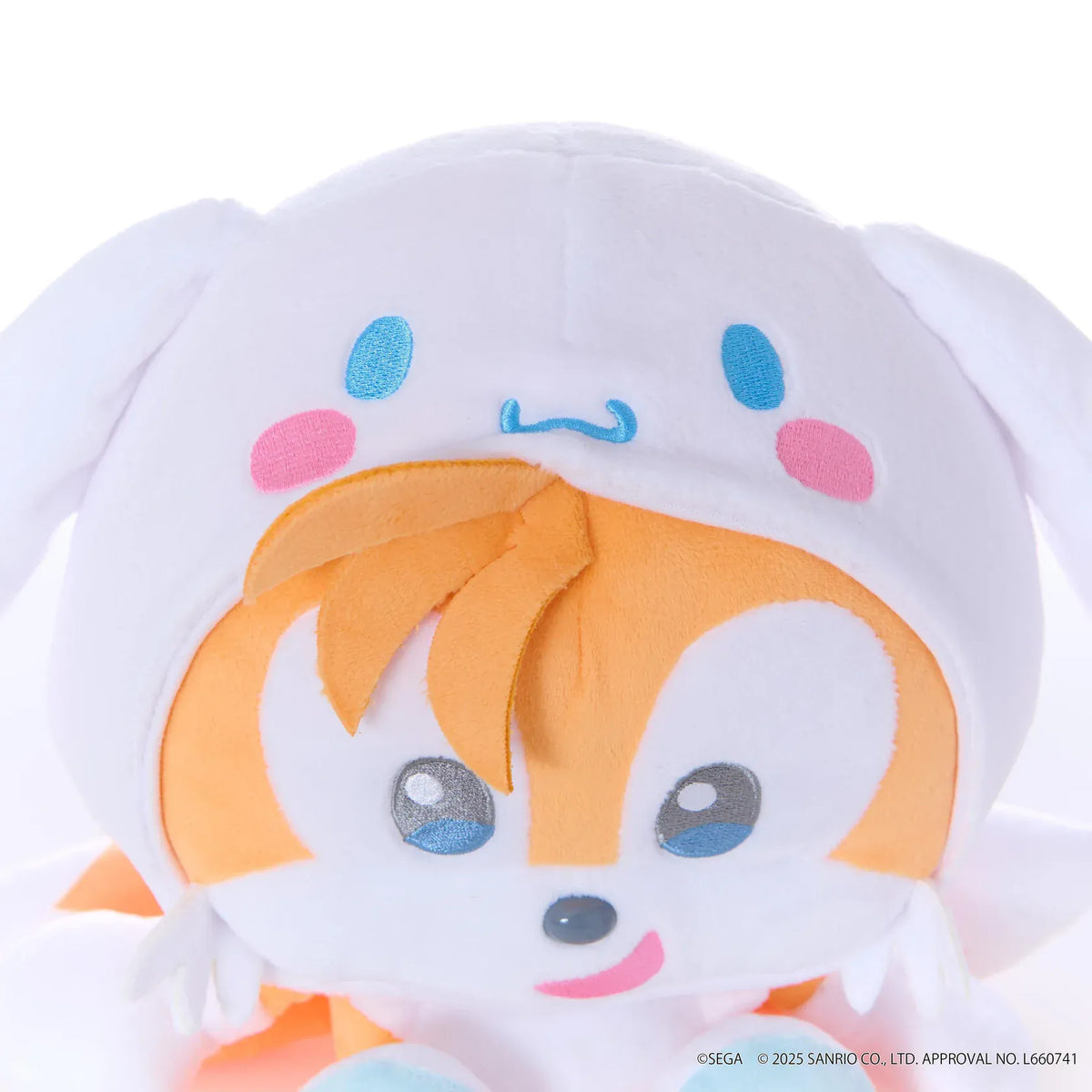 Sonic & Friends x Sanrio Tails medium plush wearing a white Cinnamoroll hood with long ears, blue eyes, and pink cheeks.