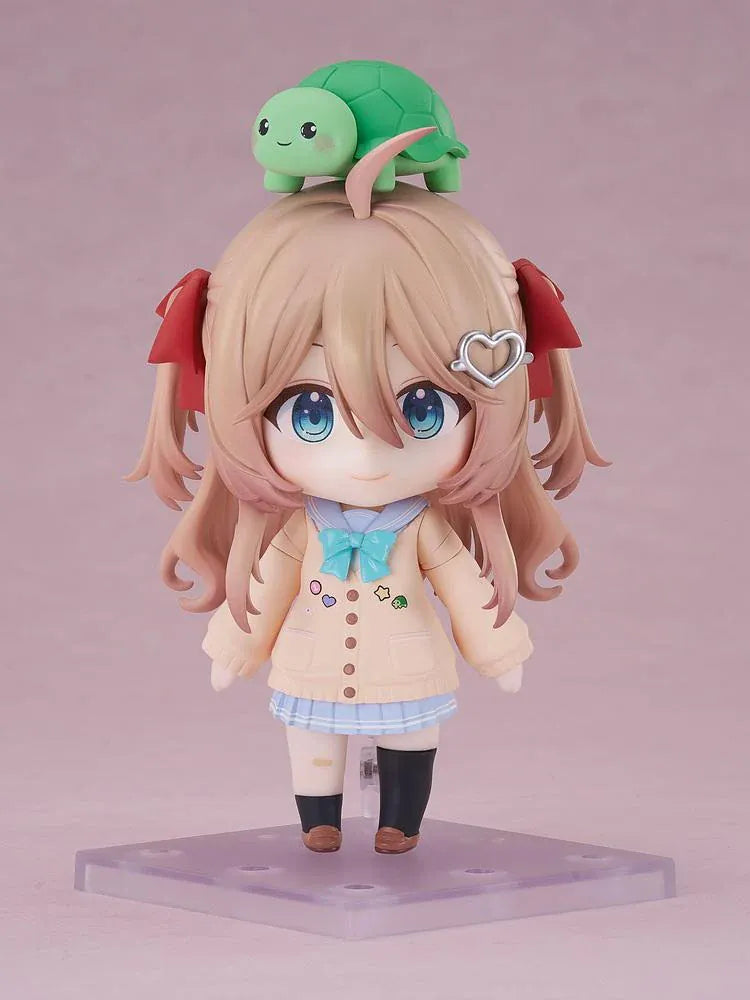 Neuro-sama Nendoroid figure with light brown hair, red ribbons, a heart hair clip, peach cardigan, turquoise bow, and a green turtle on her head.