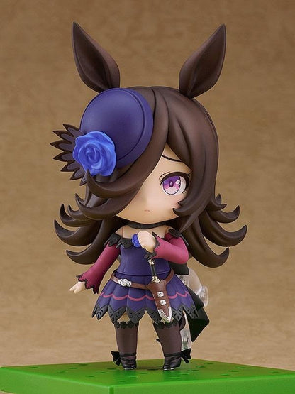 Umamusume Pretty Derby Nendoroid Rice Shower Figure (Rerelease) featuring a brown-haired horse girl with purple eyes, a miniature hat decorated with a blue rose, and an elegant purple and black racing outfit.