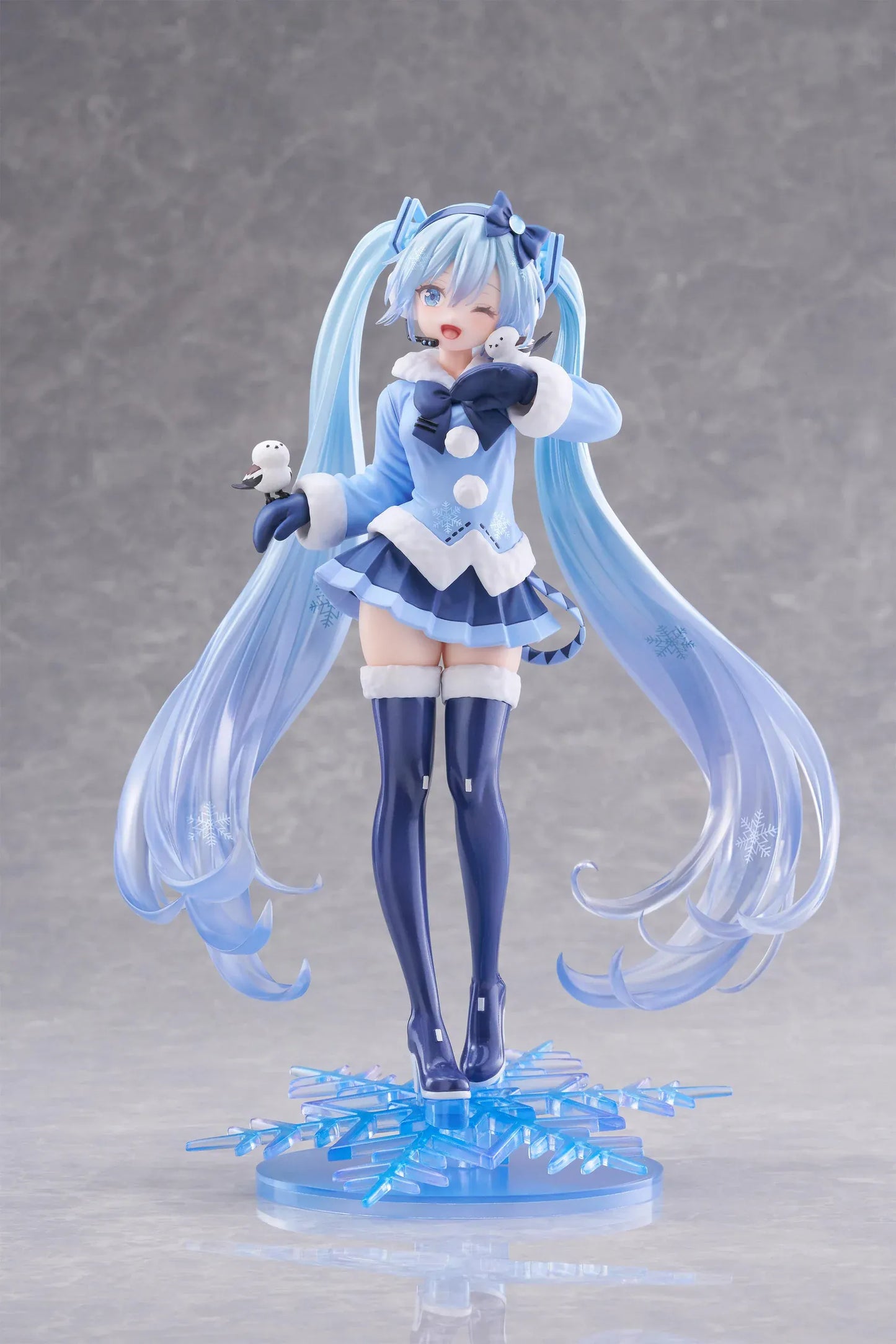 Vocaloid AMP+ Snow Miku All Stars 2012 Ver. Figure with icy blue twin-tails, winter outfit, bird details, and snowflake display base