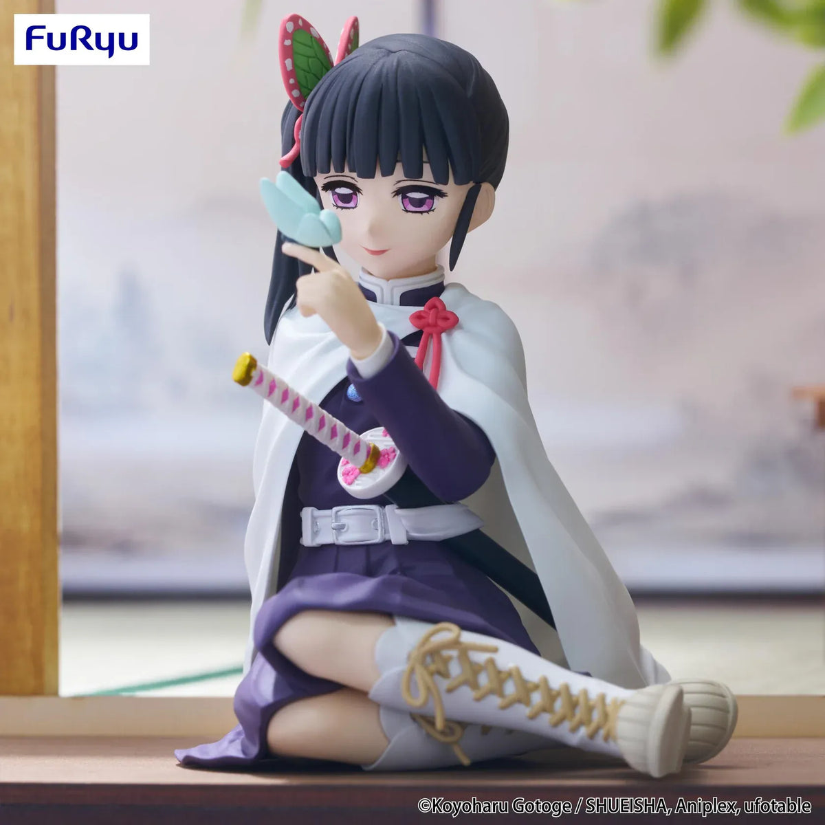 Kanao Tsuyuri Noodle Stopper figure seated in her Demon Slayer uniform and white cape while holding a blue butterfly.