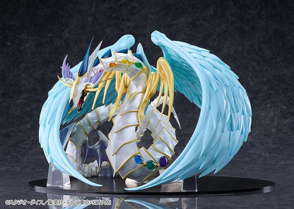Yu-Gi-Oh! GX Rainbow Dragon figure with a pearlescent armored body, multicolored crystals, gold accents, and translucent blue wings.