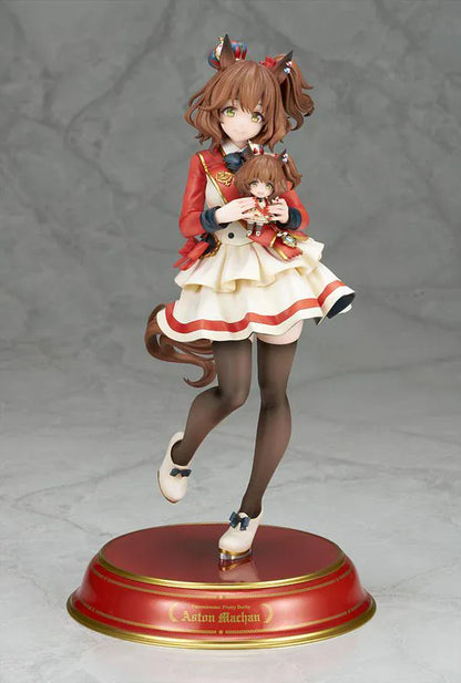 UmaMusume Pretty Derby Aston Machan 1/7 Scale Figure featuring Aston Machan with horse ears, short brown hair, red-and-cream outfit, plush doll accessory, and themed display base.