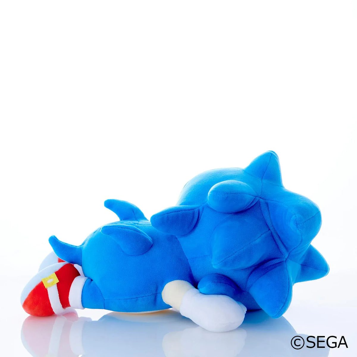 Sonic & Friends Sonic sleeping plush lying on his side with closed eyes, white gloves, and red shoes.