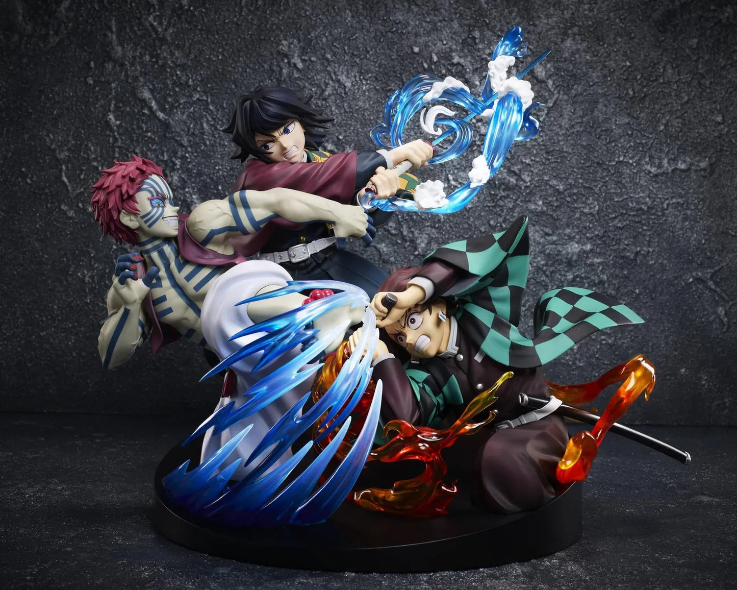 Demon Slayer Tanjiro Kamado, Giyu Tomioka, and Akaza vignette figure featuring translucent water and fire battle effects.