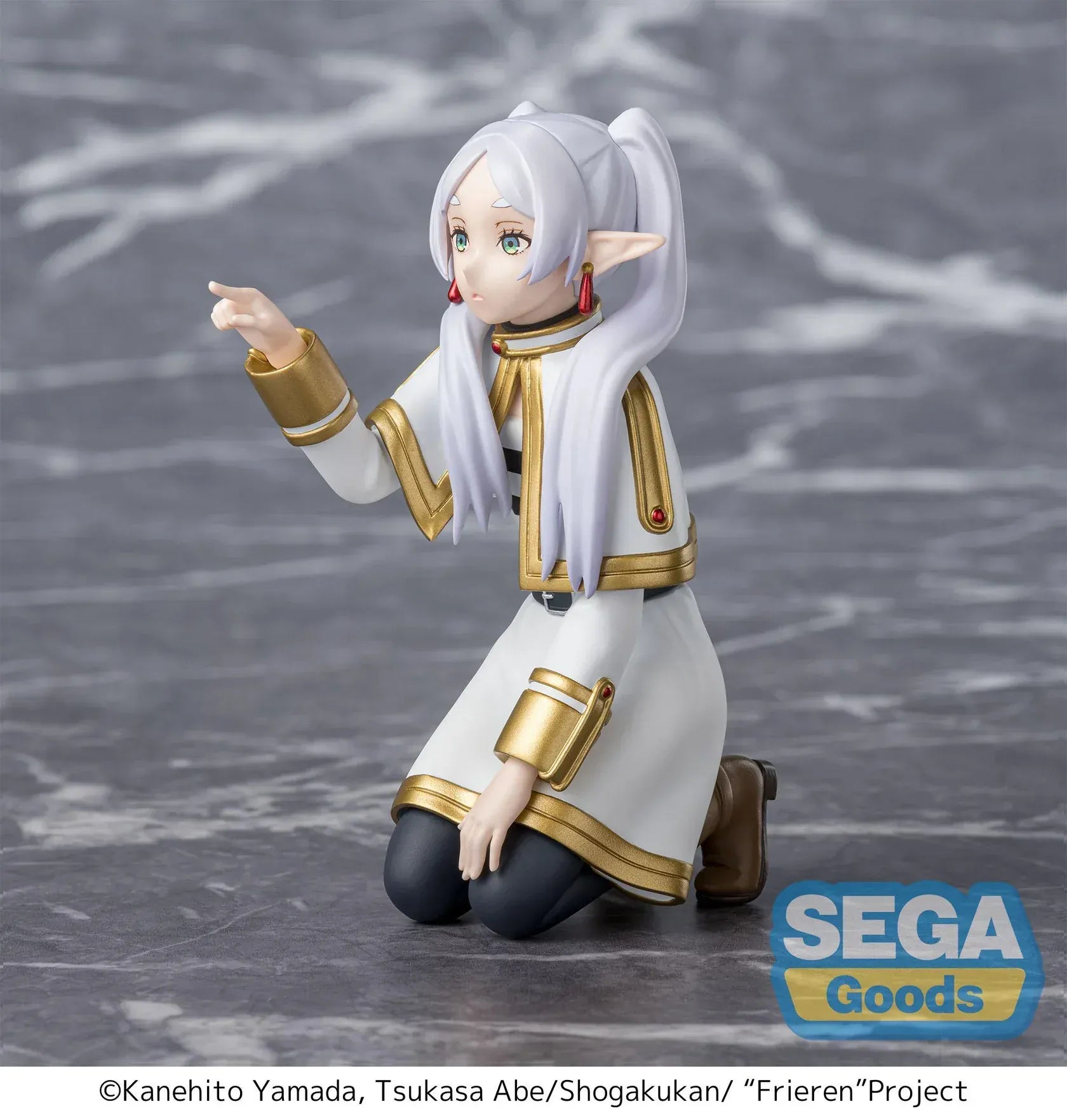 Perching figure of Frieren from Frieren: Beyond Journey’s End kneeling on a stone-like base, reaching forward to poke something, with long silver hair, elf ears, and a white-and-gold outfit.