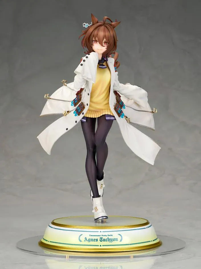 Agnes Tachyon 1/7 scale figure wearing an oversized white laboratory coat, yellow sweater, and dark tights on a decorative base.