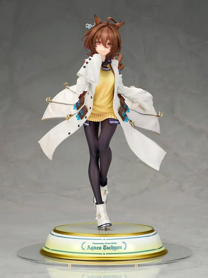 Agnes Tachyon 1/7 scale figure wearing an oversized white laboratory coat, yellow sweater, and dark tights on a decorative base.