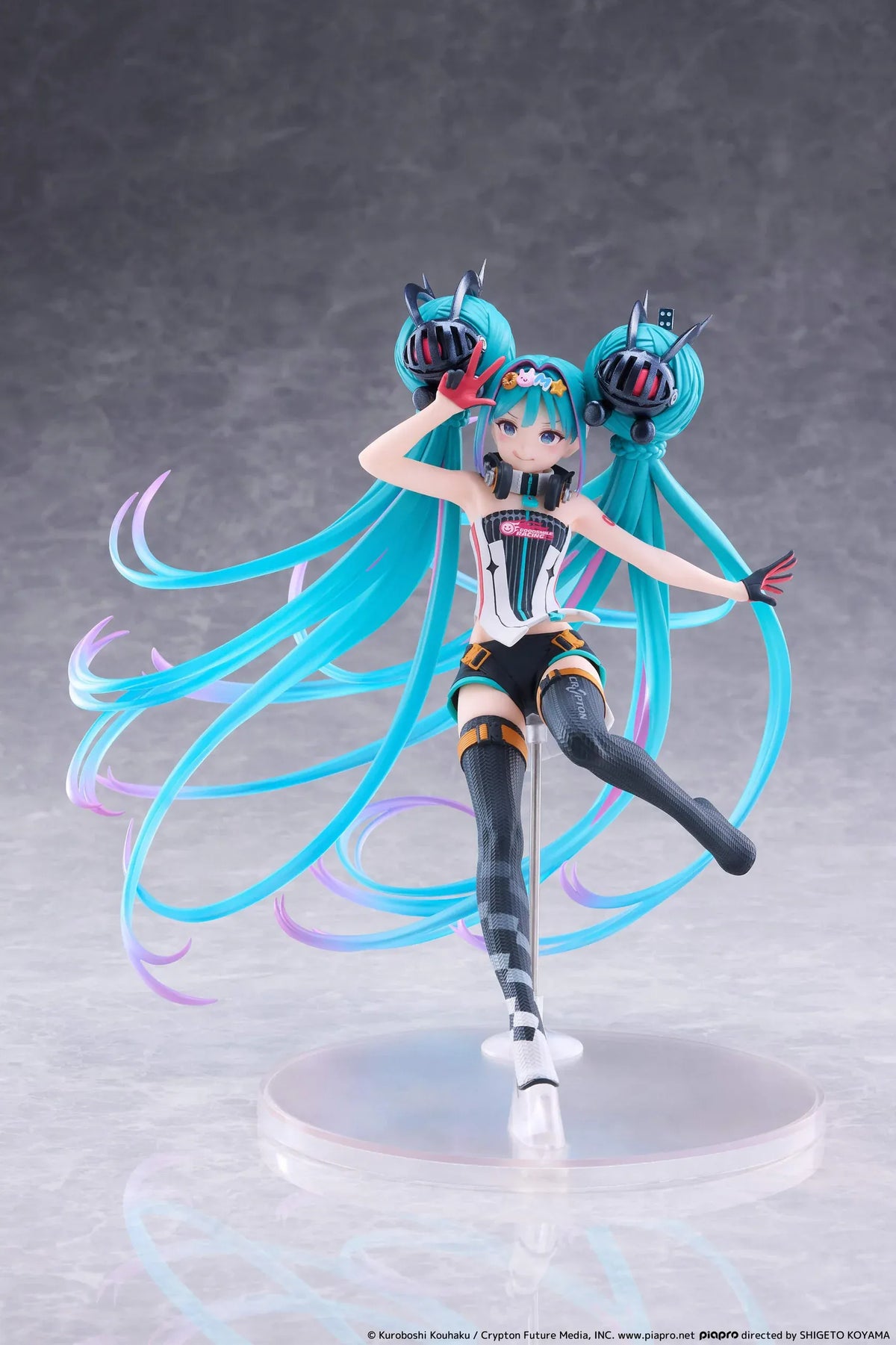 Hatsune Miku Taito Kuji Racing Miku 2026 figure wearing a futuristic racing outfit with flowing turquoise twin-tails and headphones.