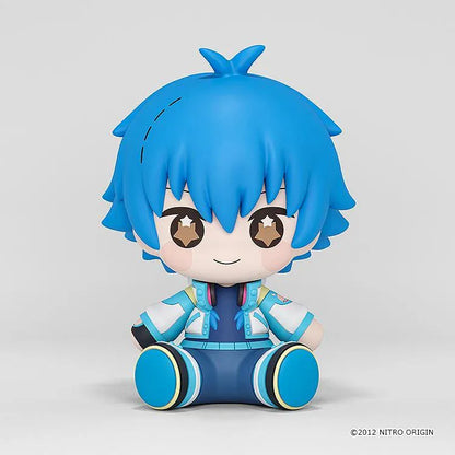 DRAMAtical Murder Huggy Good Smile Aoba figure with blue hair, star-filled eyes, headphones, and a blue-and-white outfit in a seated pose.