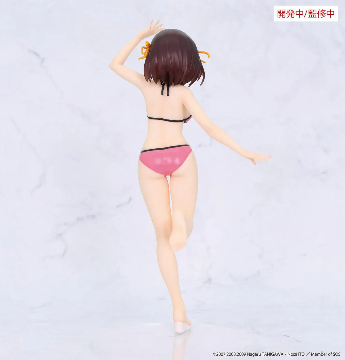 Vivit Haruhi Suzumiya figure wearing a pink swimsuit with black trim and yellow hair ribbons, smiling with one arm raised and one leg lifted.