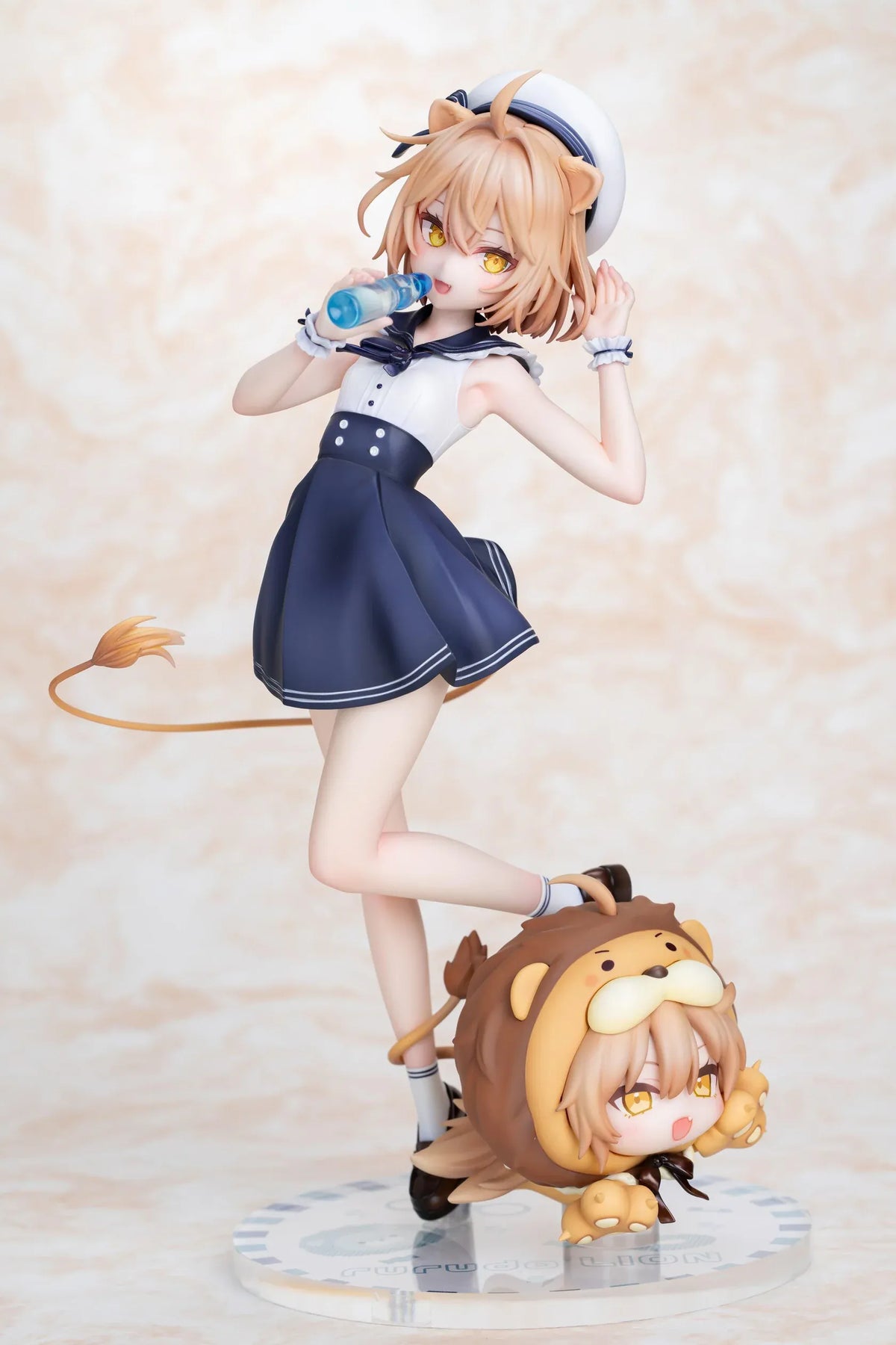 Rurudo Lion Marine Sailor Ver. figure in a navy and white sailor dress and hat, holding a blue bottle beside a chibi lion companion.