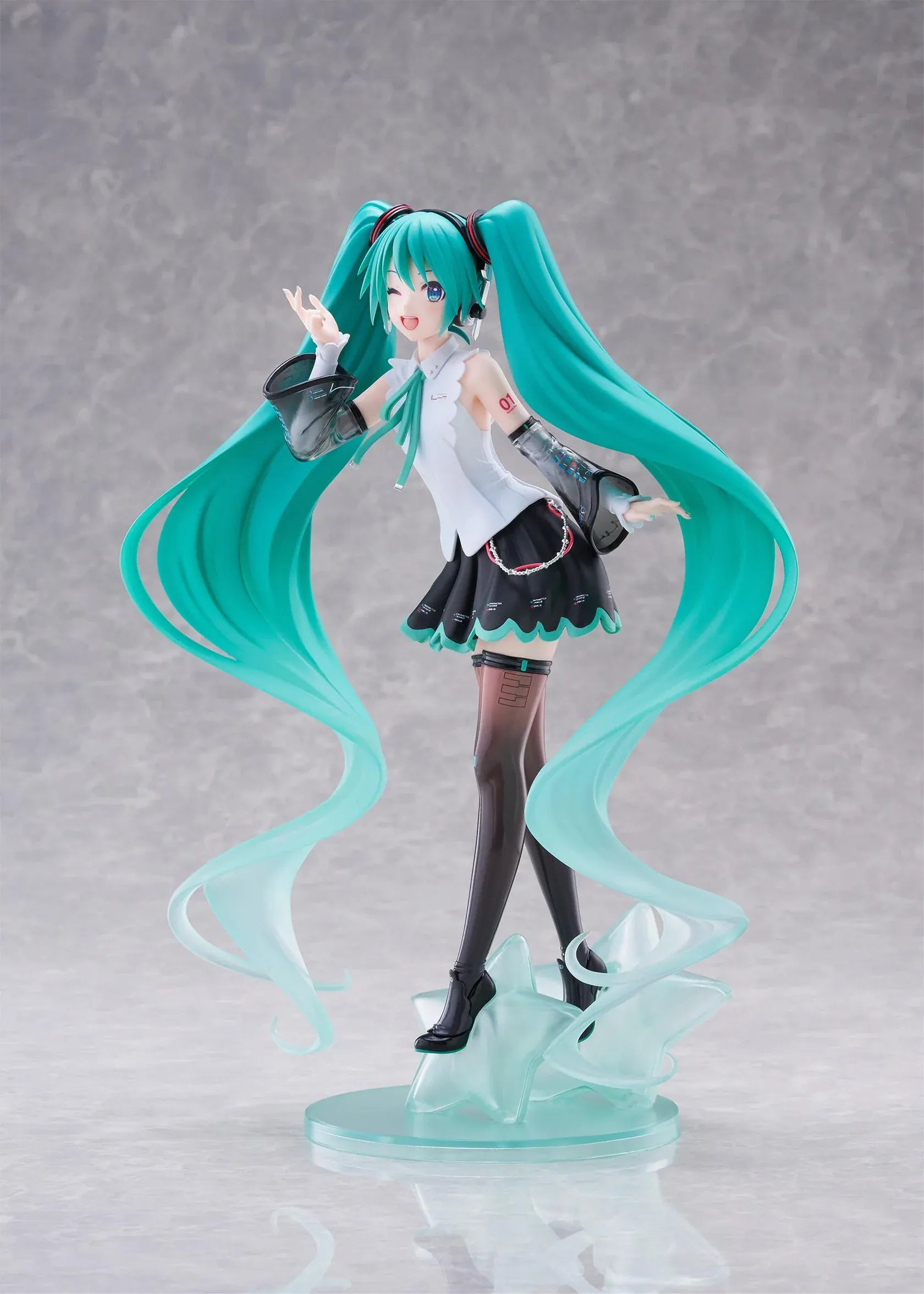 Vocaloid T-Most Hatsune Miku NT Ver. Figure featuring Miku with long teal twin tails, headphones, black-and-white outfit, wink expression, peace-sign pose, and star-themed base.