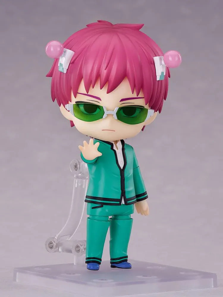 Kusuo Saiki Nendoroid with pink hair, pink-tipped head accessories, green glasses, and a teal school uniform, posed with one hand extended.