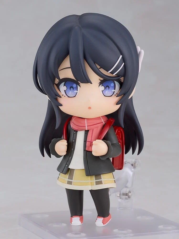 Rascal Does Not Dream Series Nendoroid Knapsack Kid Figure featuring a black-haired anime girl with blue eyes wearing a dark jacket, pink scarf, yellow plaid skirt, black tights, and pink sneakers while carrying a red backpack.