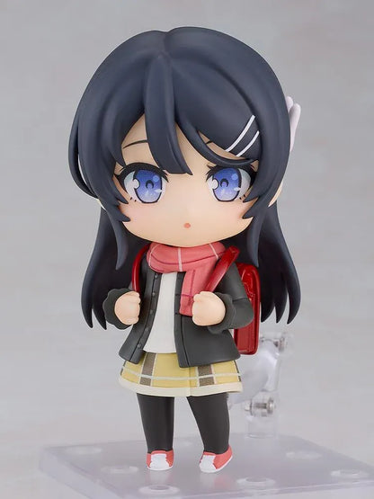 Rascal Does Not Dream Series Nendoroid Knapsack Kid Figure featuring a black-haired anime girl with blue eyes wearing a dark jacket, pink scarf, yellow plaid skirt, black tights, and pink sneakers while carrying a red backpack.
