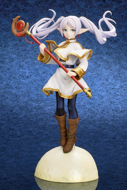 Frieren vs Aura 1/7 scale figure holding a red staff while wearing her white-and-gold mage outfit on a rounded display base.