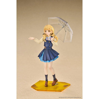 Gakuen iDOLM@STER Kotone Fujita Ameagari no Iris Before Special Training Ver. 1/7 Scale Figure featuring a blonde-haired anime girl with twin braids wearing a navy-blue school uniform and holding a transparent umbrella on a yellow display base.