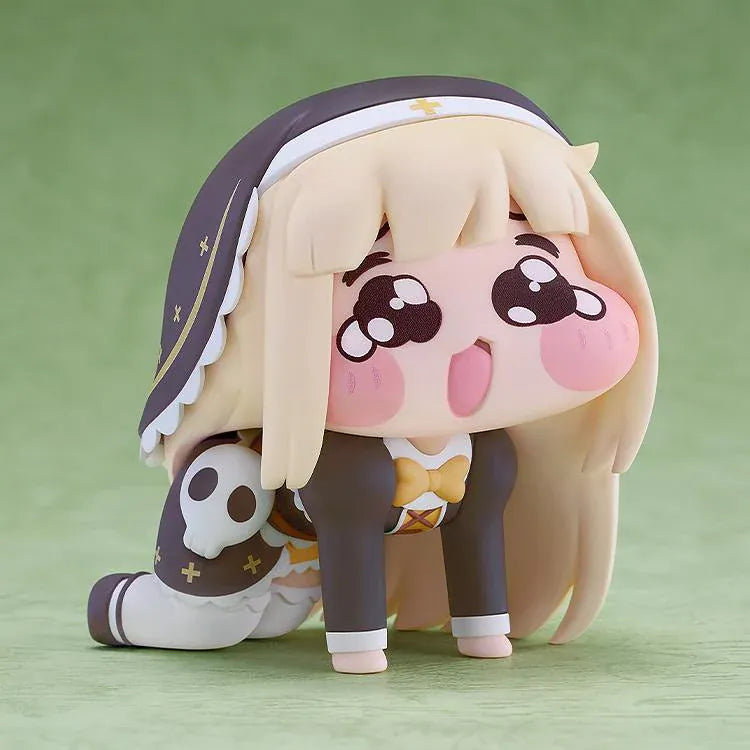 POP UP PARADE Petite Speaki figure with blonde hair, sparkling eyes, rosy cheeks, and a dark hood with gold accents and a skull detail.
