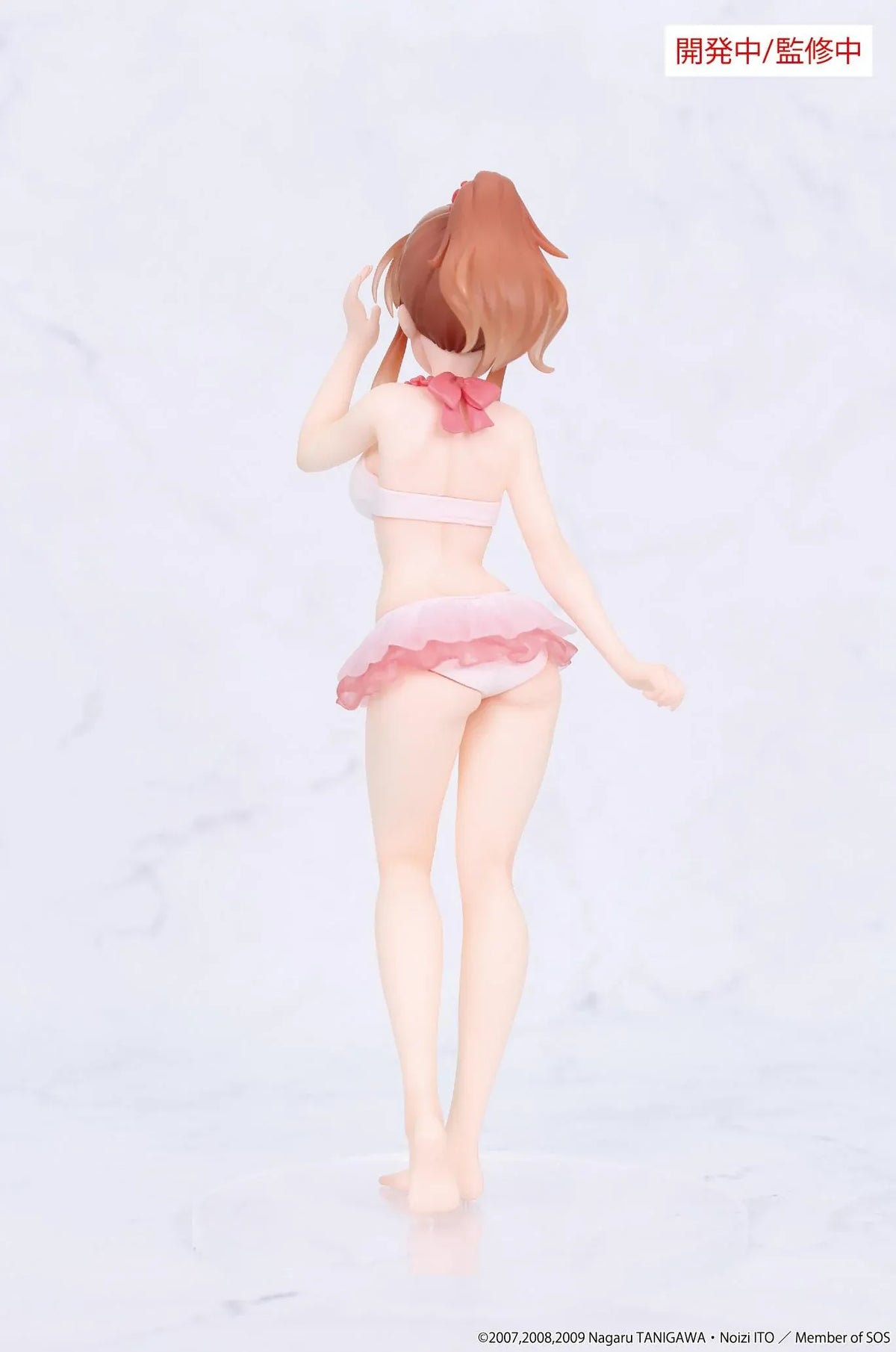 Vivit Mikuru Asahina figure with orange-brown hair, wearing a pink ruffled swimsuit with a red bow, smiling with one hand raised near her bangs.
