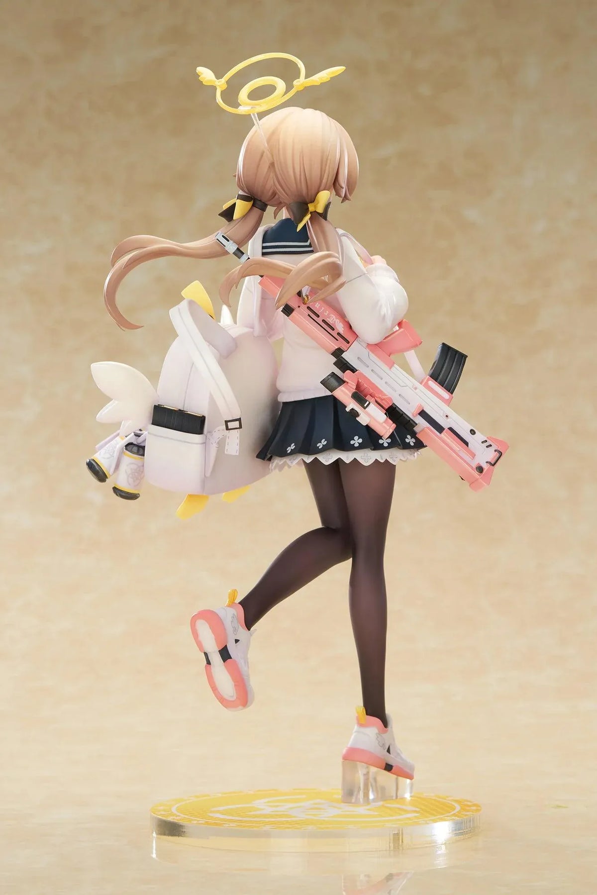 Blue Archive Hifumi figure smiling with one foot lifted, wearing a white cardigan and navy skirt, carrying a bird-themed bag and rifle on a yellow base.