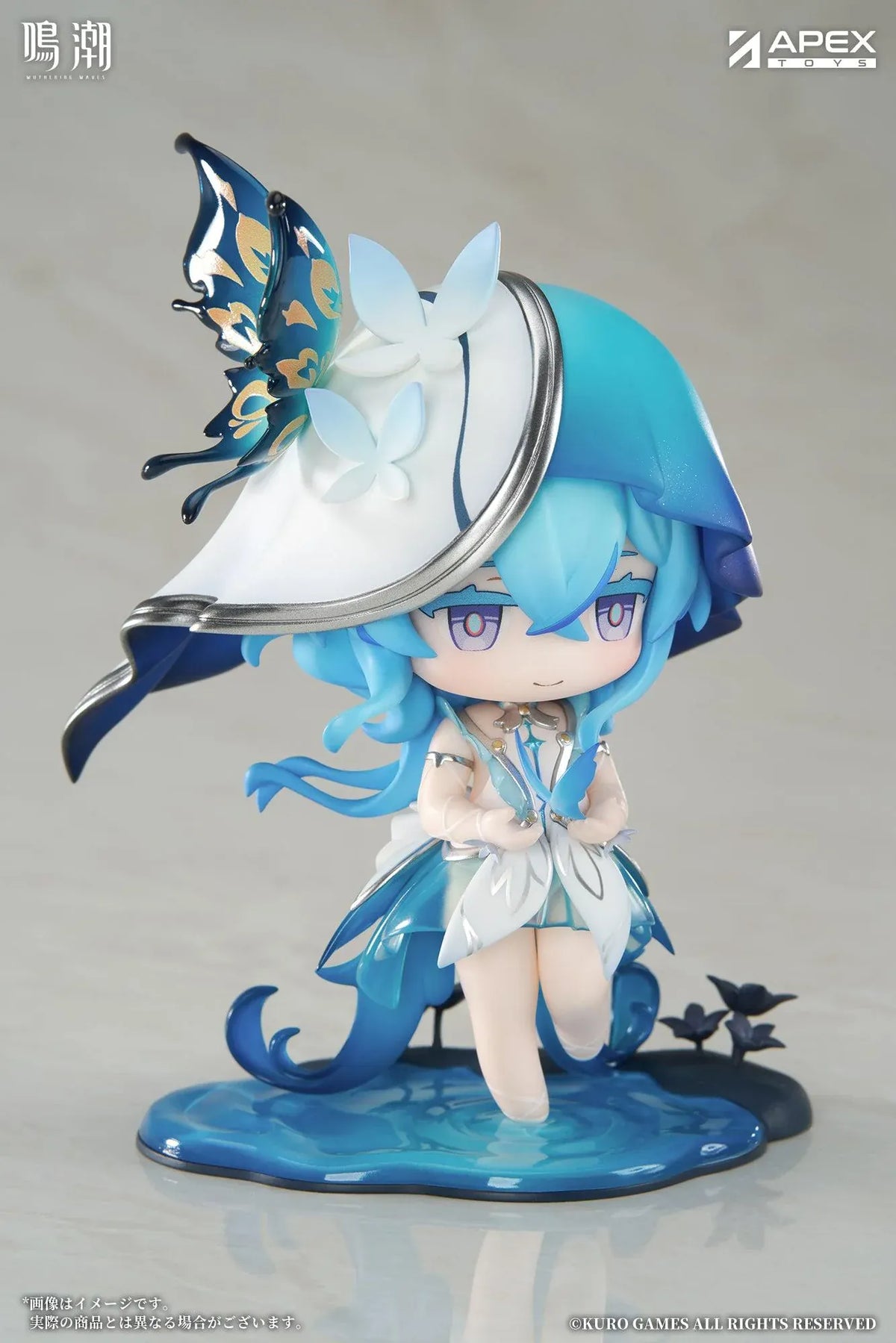 Chibi Shorekeeper Jinseki Series figure with blue hair, a butterfly-decorated headpiece, and a blue butterfly held in her hands, standing on a water-inspired base.