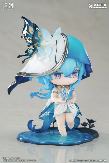 Chibi Shorekeeper Jinseki Series figure with blue hair, a butterfly-decorated headpiece, and a blue butterfly held in her hands, standing on a water-inspired base.
