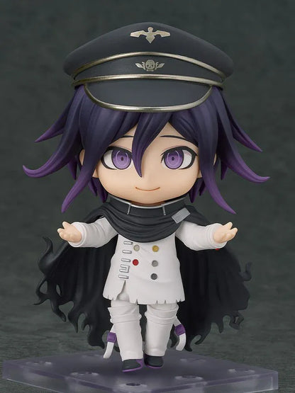 Nendoroid Kokichi Oma with purple hair, violet eyes, a black peaked cap and cape, and a white outfit, smiling with both arms extended.