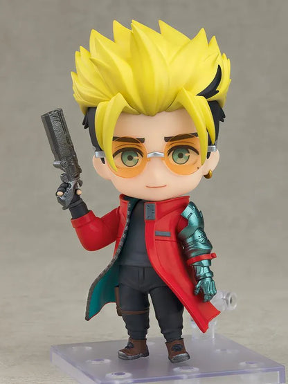 TRIGUN STARGAZE Vash the Stampede Nendoroid with spiky blond hair, orange glasses, a red coat, metallic teal mechanical arm, and raised handgun.