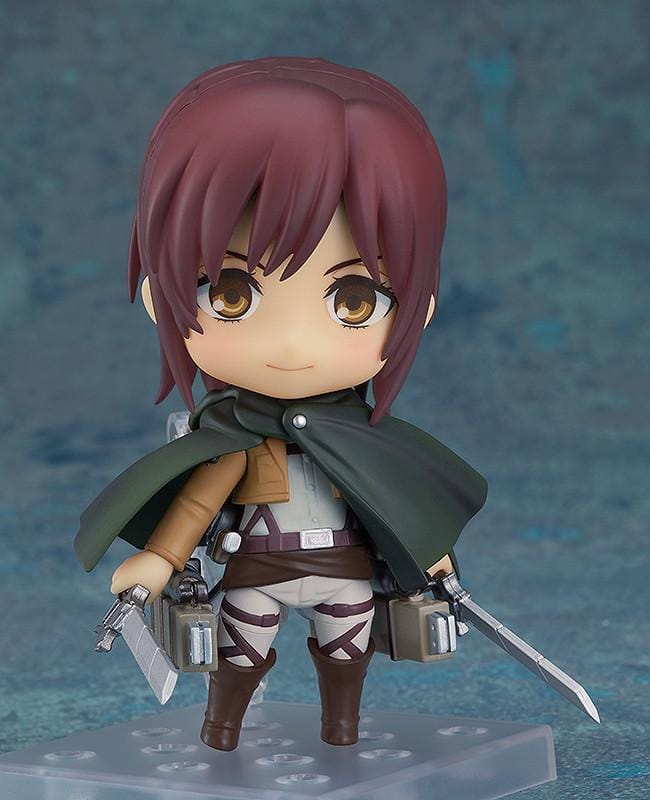 Attack on Titan Nendoroid Sasha Braus rerelease figure wearing her Survey Corps uniform and green cloak with dual blades and maneuvering gear.