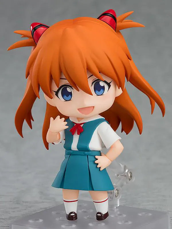 Rebuild of Evangelion Nendoroid Asuka Shikinami Langley Figure Rerelease featuring Asuka with orange twin tails, blue eyes, school uniform, and cheerful waving pose.