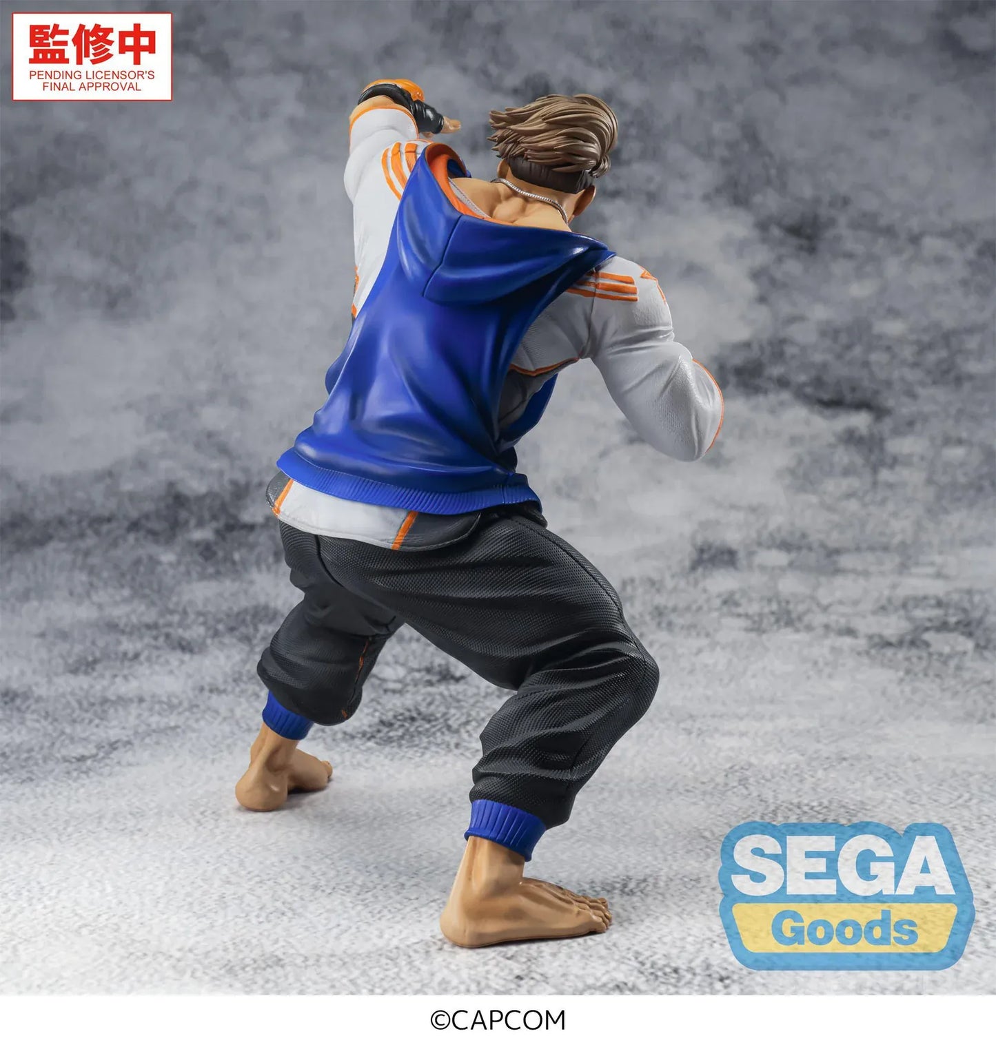 Street Fighter 6 FiGURiZMa Luke Figure in a dynamic fighting stance with blue and orange outfit and fingerless gloves