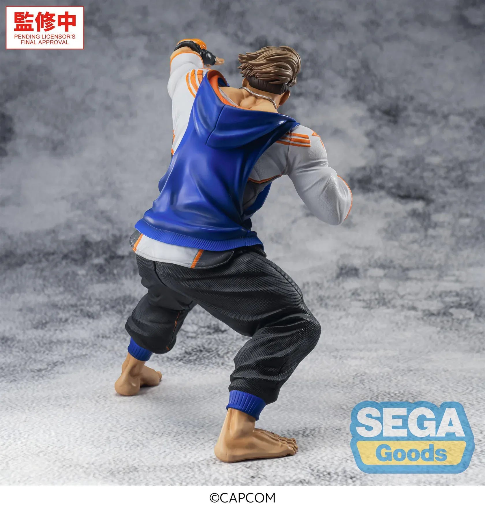 Street Fighter 6 FiGURiZMa Luke Figure in a dynamic fighting stance with blue and orange outfit and fingerless gloves